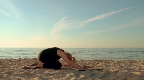 Calm Woman Practicing Yoga at Sea Girl Making Stretching Pose on Fitness Mat at Sunset Beach