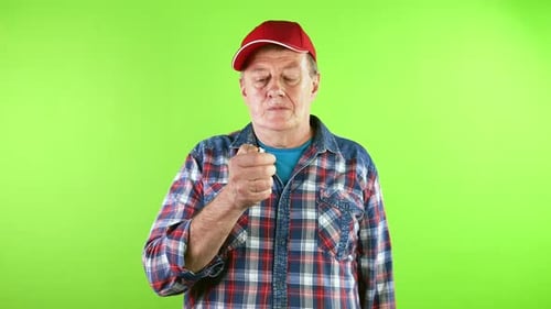 Man Demonstrates a Lighter on a Green Screen