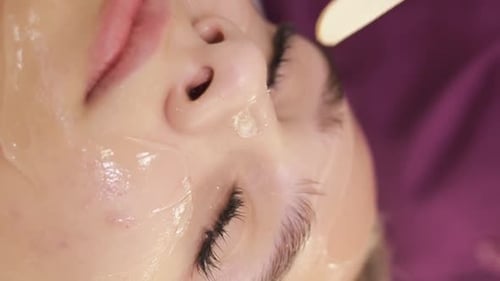 Woman Getting Facial Treatment with Gel