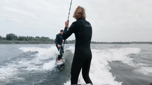 Man Wake Surfing on Lake Pulled by Boat