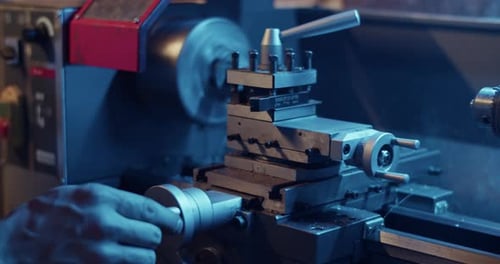 Crop Worker Using Lathe Machine in Garage