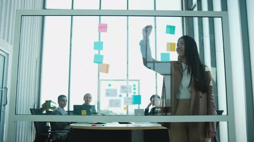 Business Team Brainstorming Ideas on Glass Board
