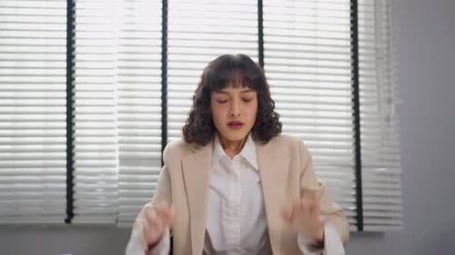 Frustrated Asian young businesswoman overwork late in office workplace.