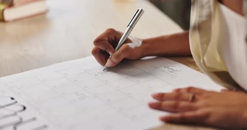 Woman Planning in Calendar at Desk