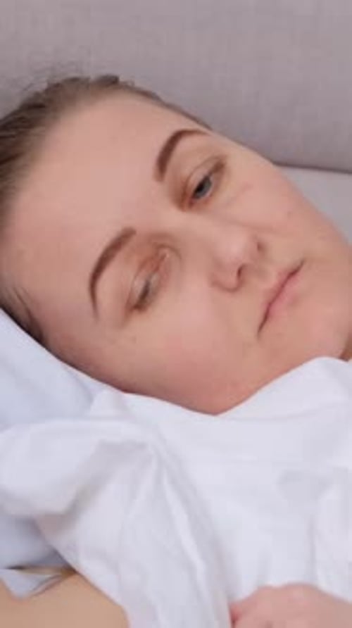 Woman Receiving a Head and Neck Massage in Bed