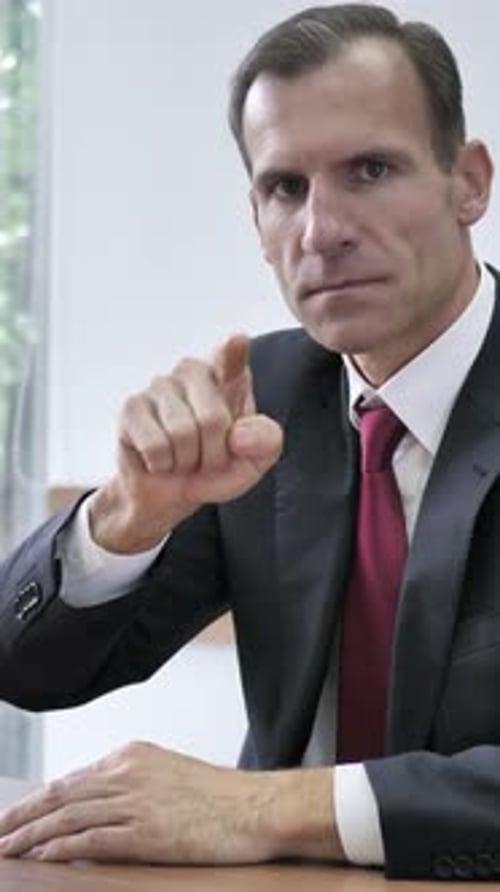 Businessman Pointing Toward Camera, Vertical Video