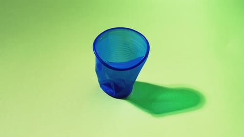 Blue Plastic Cup Bouncing Back After Being Pressed