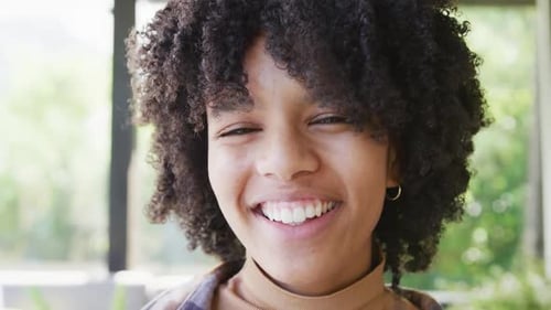 Close-Up of a Smiling Young Woman Indoors