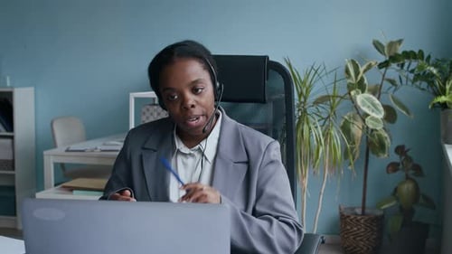 Happy Operator Looking at Camera with Smile during Online Consultation