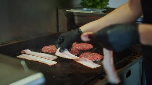 Burgers and bacon sizzling on the grill