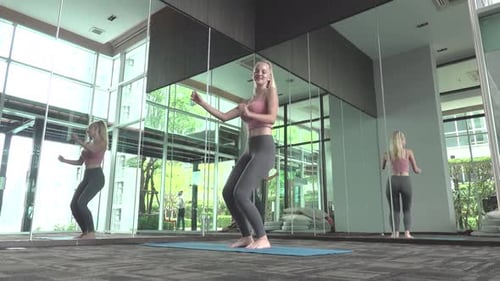 Young attractive woman in sportswear dance in fitness club.
