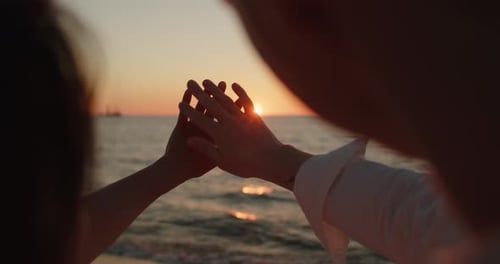 Romantic Couple Holding Hands at Beach Sunset