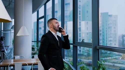 Professional Man Talking on Phone in Modern Office