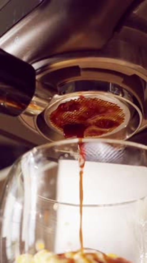 Vertical video. Slow Motion Close Up Of Espresso Machine Showing Incorrect Bottomless Portafilter