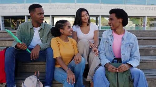 Young Group of Gen Z College Students Hanging Out Sitting on Staircase at Campus