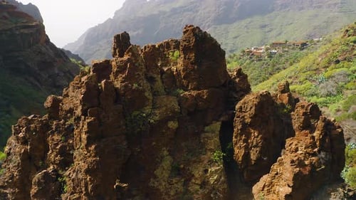 Rocky Volcanic Green Mountains Surrounded By White Haze Clouds in Teno National Park Masca Gorge