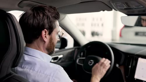 Businessman Holding Car Key Inside Modern Vehicle Dealership