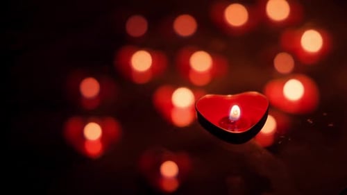 Heart-Shaped Candle Burning in the Dark