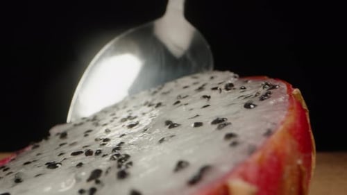 Dragonfruit Cut With Spoon On Black Background