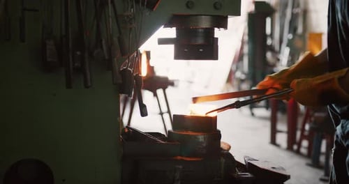 Blacksmith Shaping Red Hot Steel with Tongs