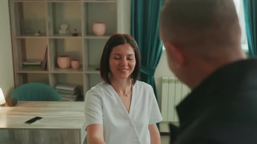 Woman Talking to Man in Office Meeting