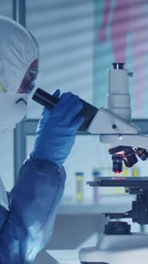 Scientist Using Microscope in Medical Laboratory