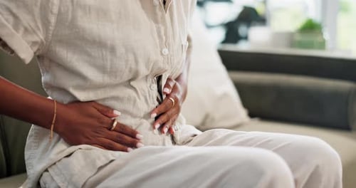 Hands, stomach pain and person with cramps, gut health and stress in abdomen with gastrointestinal