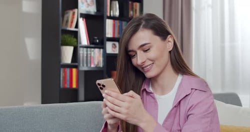 Close Up of Caucasian Young Pretty Woman Texting Message on Smartphone At Home Beautiful Female