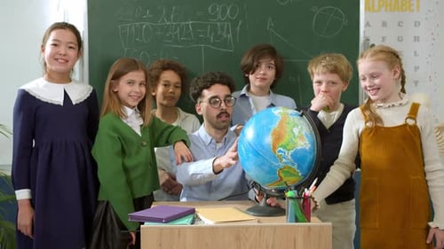 Elementary School Class Children Communicate with the Teacher Answering Question