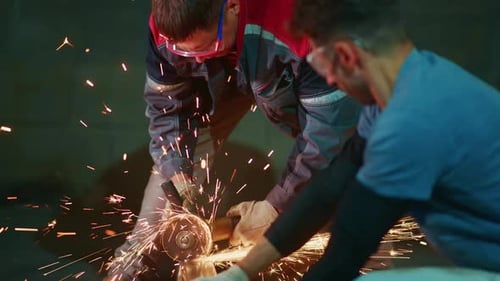 Workplace Where Experienced Technicians Perform Precise Steel Pipe Cutting Using Protective Gear and