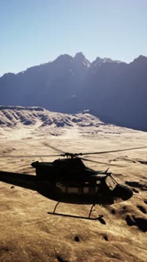 Helicopter Flying Over Mountain Range