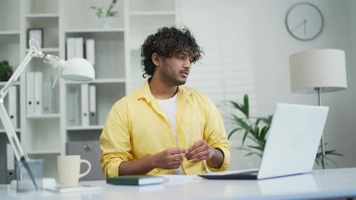 Young Man Working Remotely During a Video Conference