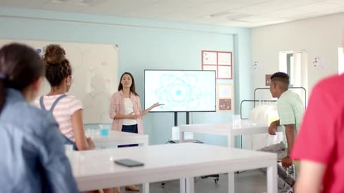 Young biracial woman teaches science in a high school classroom