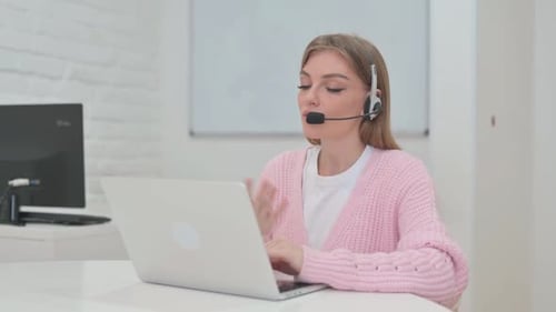 Woman with Headset in Call Center Doing Video Chat at Work