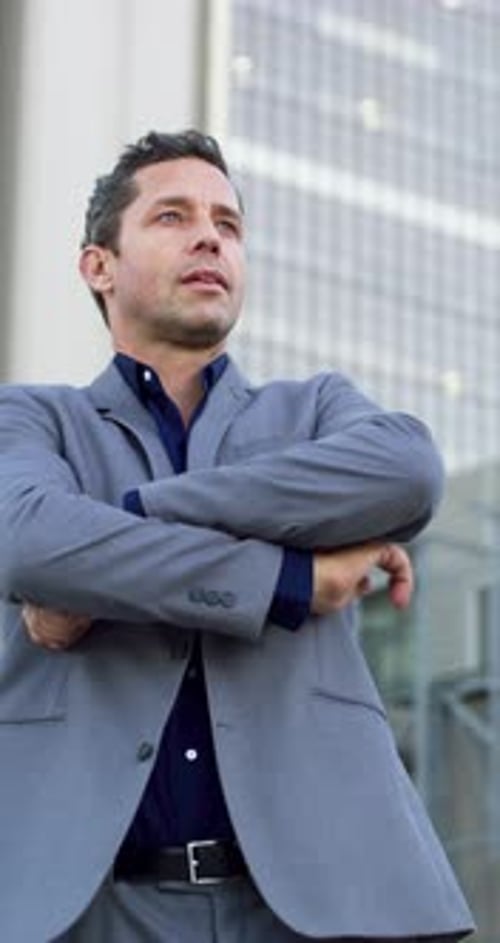 Arms crossed, vision and business man in city for real estate developer