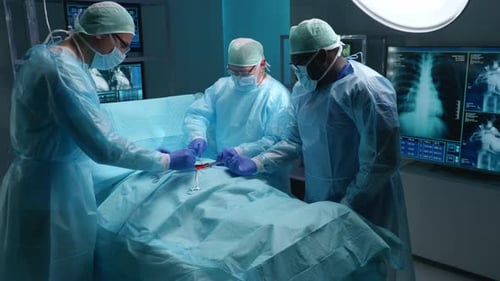 Team of Professional Medical Surgeons Performs the Surgical Operation in a Modern Hospital Doctors