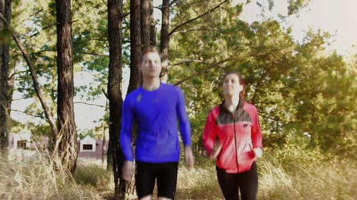 Couple Running Uphill on Mountain Trail