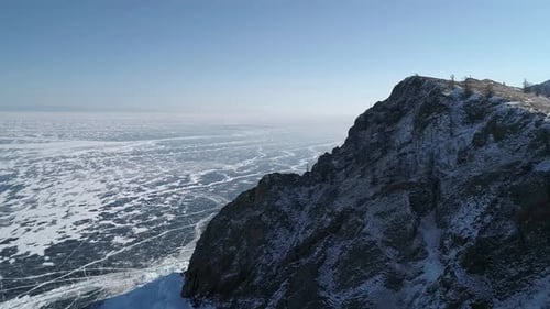 Aerial View of Cape Khoboy Olkhon Island Tall Rocks in Frozen Lake Baikal with Many People and Cars