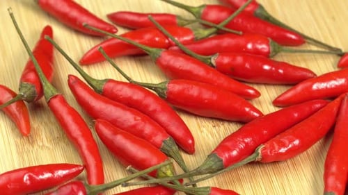 Bright Red Chili Peppers on Wooden Surface