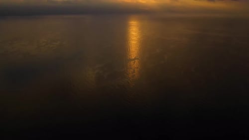 Golden sunset aerial over the tranquil ocean waters