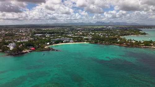Breathtaking Panoramic Aerial View of a Tropical Island Bay with Clear Turquoise Water and Mountains