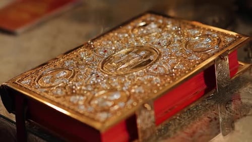 The holy book of the Bible in a golden binding on the throne in a church or temple. Greek catholic p