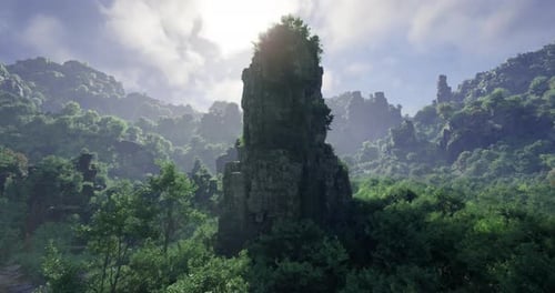 Majestic Rock Formation Surrounded By Lush Greenery in a Mountainous Terrain