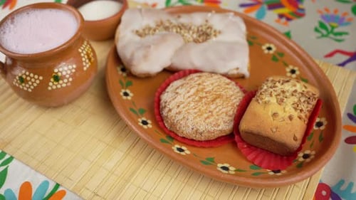 Mexican pastries with frothy drink on table