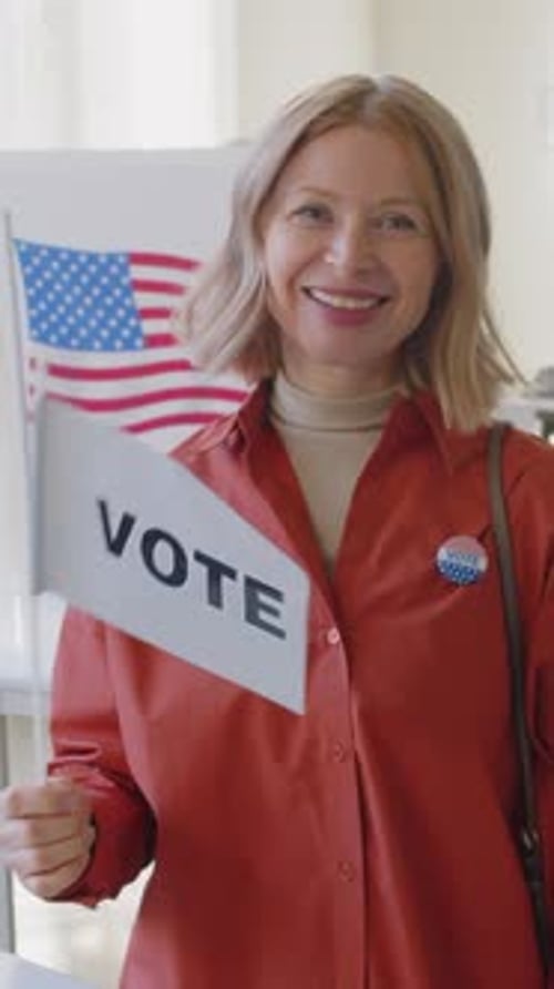 Woman Holding Vote Flag in Polling Place