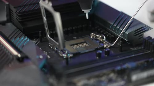 Closeup Hands of Unrecognizable Man Blowing Dust Off Slot on Motherboard Using Enema Hurricane