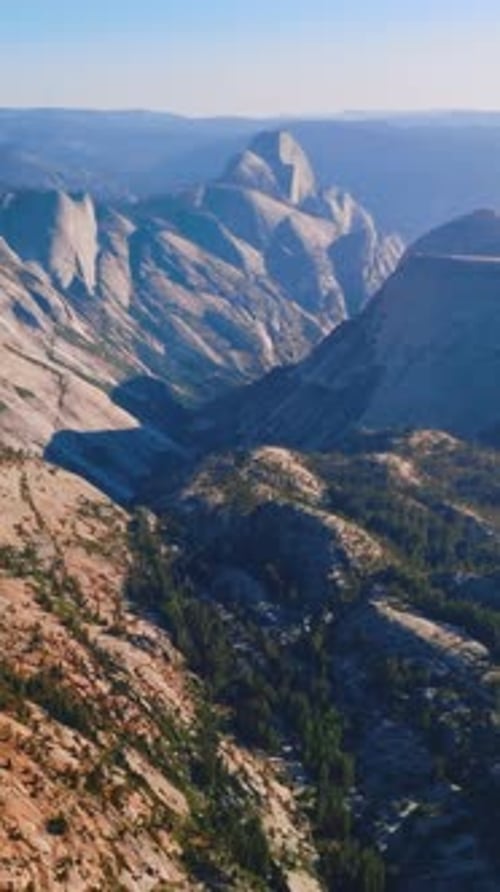 Grey rocks lit with bright sun. Mountainous landscape of Yosemite National Park, California, USA