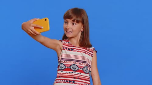Cute Girl Takes Selfie with Cell Phone
