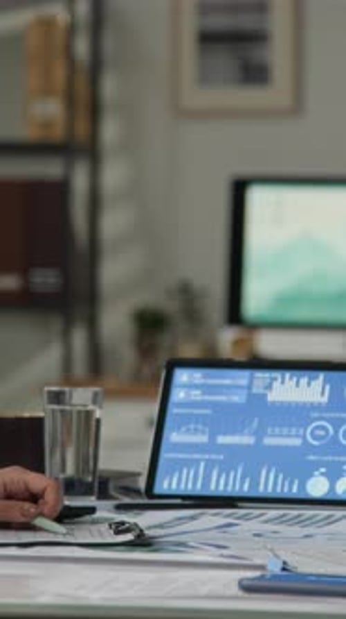 Business High Five at Desk with Analytics