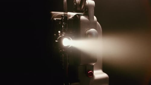 Vintage Film Projector Emitting Light in the Darkness
